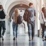 A photo of some students walking down a corridor.