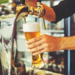 A photo of a man pouring a beer.